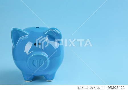Piggy bank on light blue background. Space for text Piggy bank on light blue background. Space for text 95802421