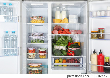 Open refrigerator full of different fresh products 95802447