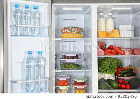 Open refrigerator full of different fresh products 95802450
