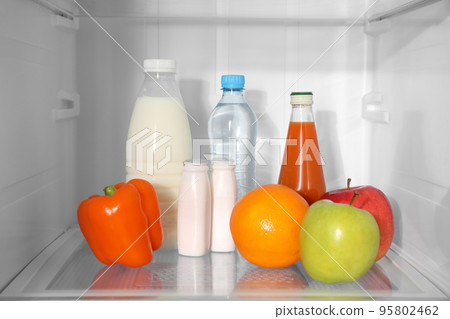 Different products on shelf inside modern refrigerator Different products on shelf inside modern refrigerator 95802462