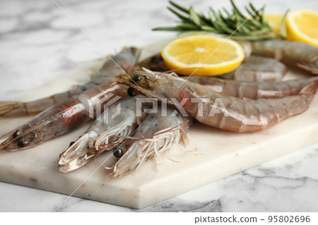 Fresh raw shrimps on marble table, closeup Fresh raw shrimps on marble table, closeup 95802696