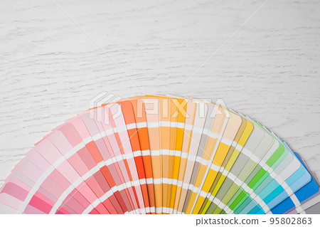 Bright palette sample and space for text on white wooden table, flat lay. Rainbow colors 95802863