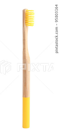 Bamboo toothbrush with yellow bristle isolated on white 95803164