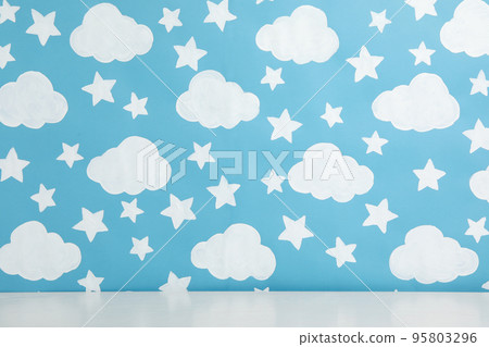 White table near wall with painted blue sky. Idea for baby room interior 95803296