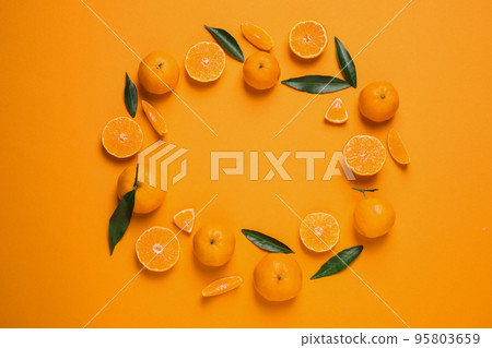 Frame made of fresh ripe tangerines and space for text on orange background, flat lay. Citrus fruit 95803659