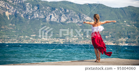 Woman walking on a pier Woman walking on a pier 95804060