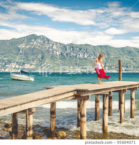 Woman walking on a pier Woman walking on a pier 95804071