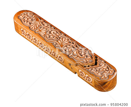 The artistic wood carving on the pencil case on a white background. Central Asia, Uzbekistan The artistic wood carving on the pencil case on a white background. Central Asia, Uzbekistan 95804200