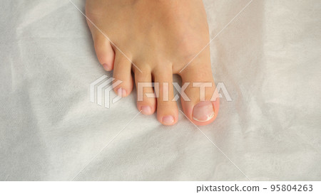 Female foot with pedicure, cosmetic treatment of feet and toenails 95804263