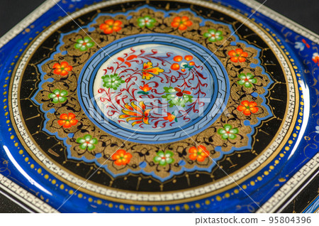 A closeup of a casket with an artistic painting. Central Asia, Uzbekistan 95804396