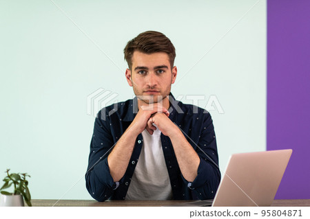 Smiling young man freelancer using laptop studying online working from home 95804871