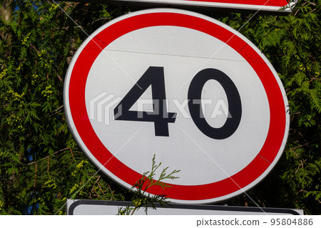 Traffic Road Signs. Speed limit traffic sign against green leaves Traffic Road Signs. Speed limit traffic sign against green leaves 95804886