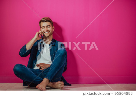 Portrait of a happy man using smartphone isolated over pink background. Portrait of a happy man using smartphone isolated over pink background. 95804893