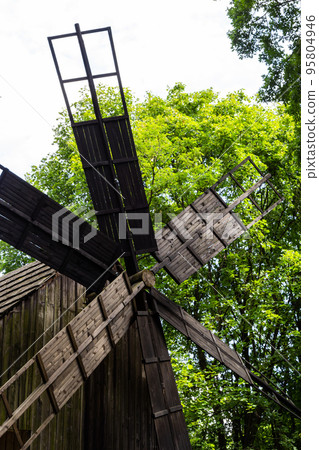 An old wooden mill in a Ukrainian village. Historical building in the forest close-up An old wooden mill in a Ukrainian village. Historical building in the forest close-up 95804946