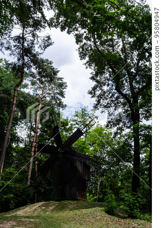 An old wooden mill in a Ukrainian village. Historical building in the forest close-up An old wooden mill in a Ukrainian village. Historical building in the forest close-up 95804947