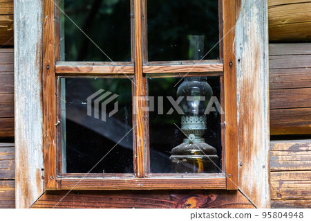 Windows of old wooden village houses made of logs Windows of old wooden village houses made of logs 95804948