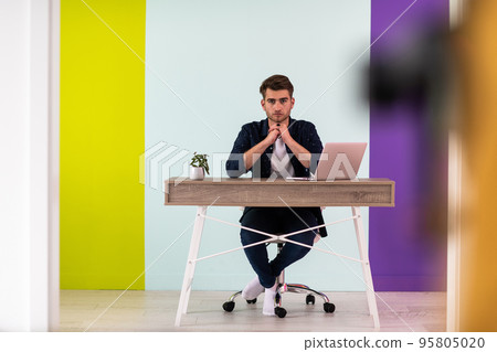 Smiling young man freelancer using laptop studying online working from home 95805020