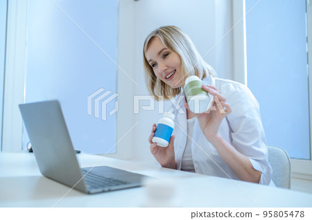 Smiling friendly general practitioner giving an online consultation Smiling friendly general practitioner giving an online consultation 95805478