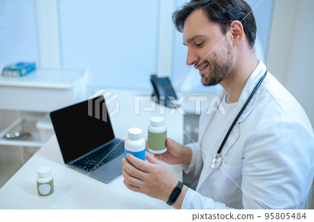 Young physician conducting a medical consultation online 95805484