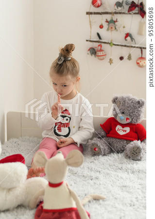 Girl playing in a room with plush toys Girl playing in a room with plush toys 95805698