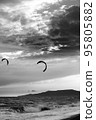 Two silhouette of power kites at sunset sky. Black and white. 95805882