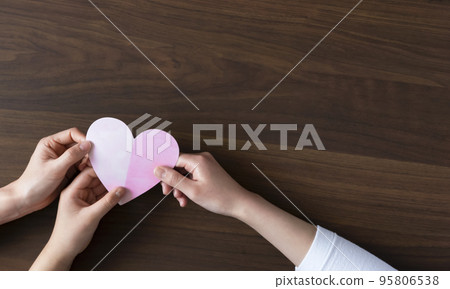 Family hands holding a heart Family hands holding a heart 95806538