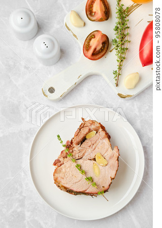 Overhead view of piece of pork neck baked in oven Overhead view of piece of pork neck baked in oven 95808078