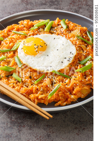 Kimchi fried rice Bokkeumbap is a type of Korean food closeup on the plate. Vertical Kimchi fried rice Bokkeumbap is a type of Korean food closeup on the plate. Vertical 95808681
