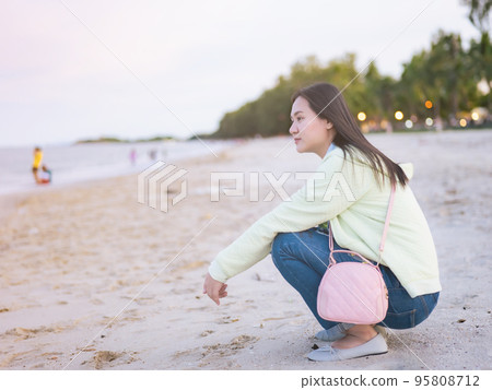 Asian women traveling to the sea sitting on the beach looking around. free sample release Relax in the atmosphere There is a backlight bokeh. Asian women traveling to the sea sitting on the beach looking around. free sample release Relax in the atmosphere There is a backlight bokeh. 95808712