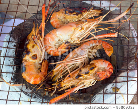 Grilled big shrimp that's being cooked on charcoal grill 95809352