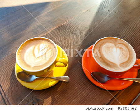 Latte art coffee and wooden desk 95809468