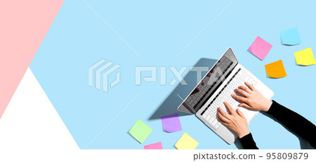 Laptop computer with many sticky notes 95809879