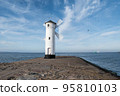 Old windmill lighthouse in Swinoujscie, a port in Poland on the Baltic Sea. 95810103