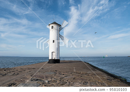 Old windmill lighthouse in Swinoujscie, a port in Poland on the Baltic Sea. 95810103