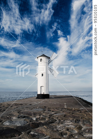 Old windmill lighthouse in Swinoujscie, a port in Poland on the Baltic Sea. Old windmill lighthouse in Swinoujscie, a port in Poland on the Baltic Sea. 95810105