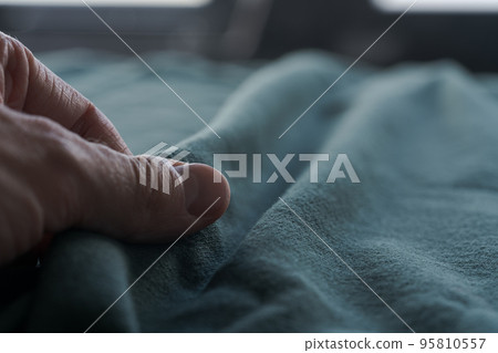 man hand touching blue linen cotton mixed fabric 95810557