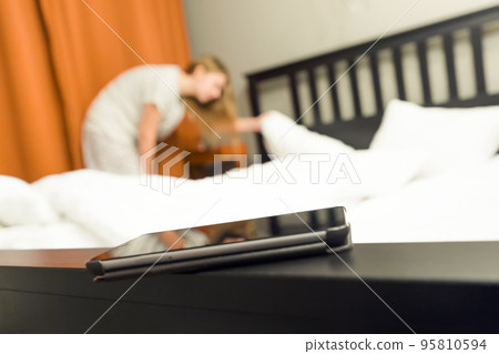 Women try to find a phone at bedroom 95810594