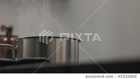 Slow motion steam rising from saucepan with copy space Slow motion steam rising from saucepan with copy space 95810868