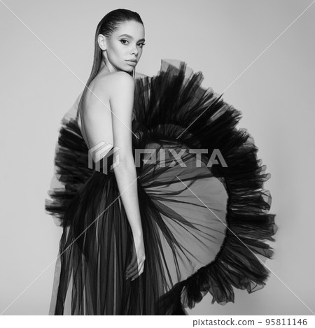 Beautiful woman pose in studio. Art portrait of a model in a bla Beautiful woman pose in studio. Art portrait of a model in a bla 95811146