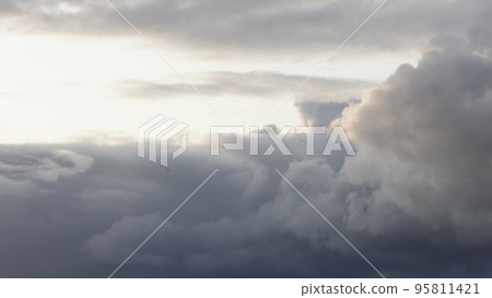 Slow motion birds flying in front of cloudscape with sunset light Slow motion birds flying in front of cloudscape with sunset light 95811421