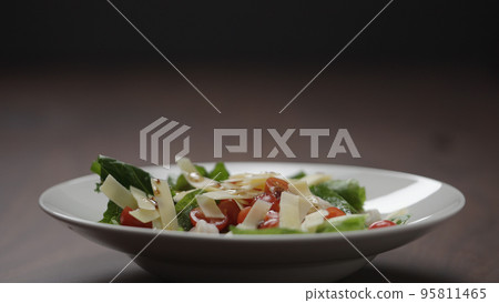making salad pour dressing over in white bowl making salad pour dressing over in white bowl 95811465