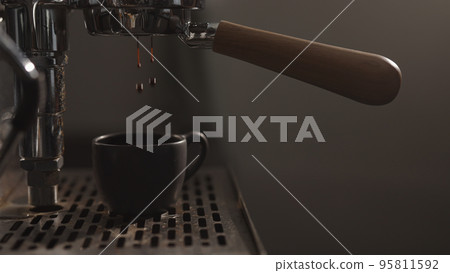 dark early morning shot of coffee machine making esprresso dark early morning shot of coffee machine making esprresso 95811592