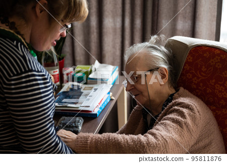 85 yo senior woman taking care of her 40 yo daughter with the Down Syndrome, Belgium 85 yo senior woman taking care of her 40 yo daughter with the Down Syndrome, Belgium 95811876