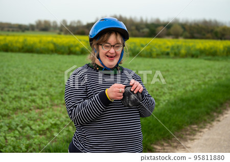 Portrait of a happy 40 yo woman with the Down Syndrome in the fields of Tienen, Belgium Portrait of a happy 40 yo woman with the Down Syndrome in the fields of Tienen, Belgium 95811880