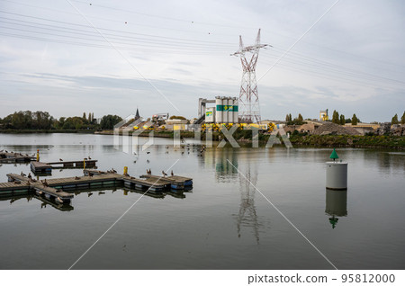Zemst, Flemish Brabant Region, Belgium, Wooden jetty  and industrial activity of the Inter Beton company reflecting in the water of the port 95812000