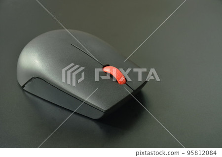 gray computer mouse on black laptop background gray computer mouse on black laptop background 95812084