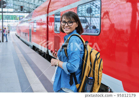 Woman waiting for railway public electric transport on platform of city station Woman waiting for railway public electric transport on platform of city station 95812179