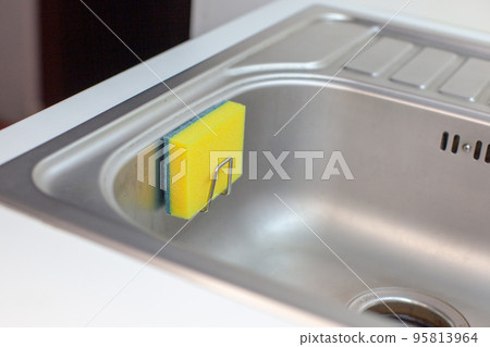 Sponge for washing dishes. Storage ideas, sink in the kitchen.  95813964