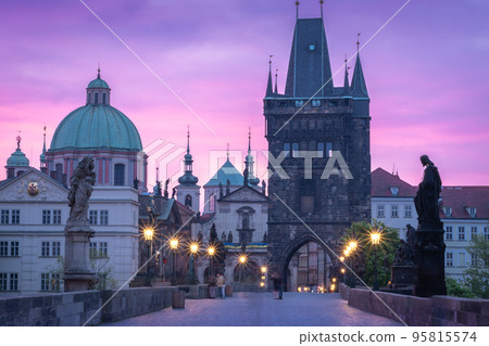 Colorful sunrise at historical city centre, Charles bridge lined with street lamps, Prague, Czechia 95815574