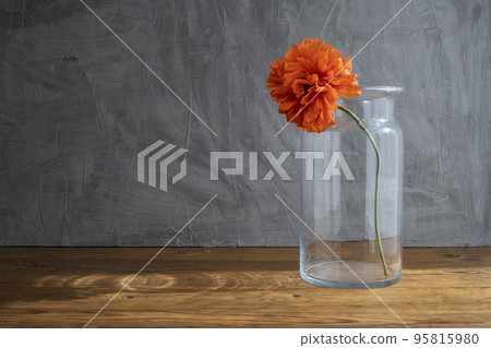 Still life in a rustic style with glass vase and red poppies Still life in a rustic style with glass vase and red poppies 95815980